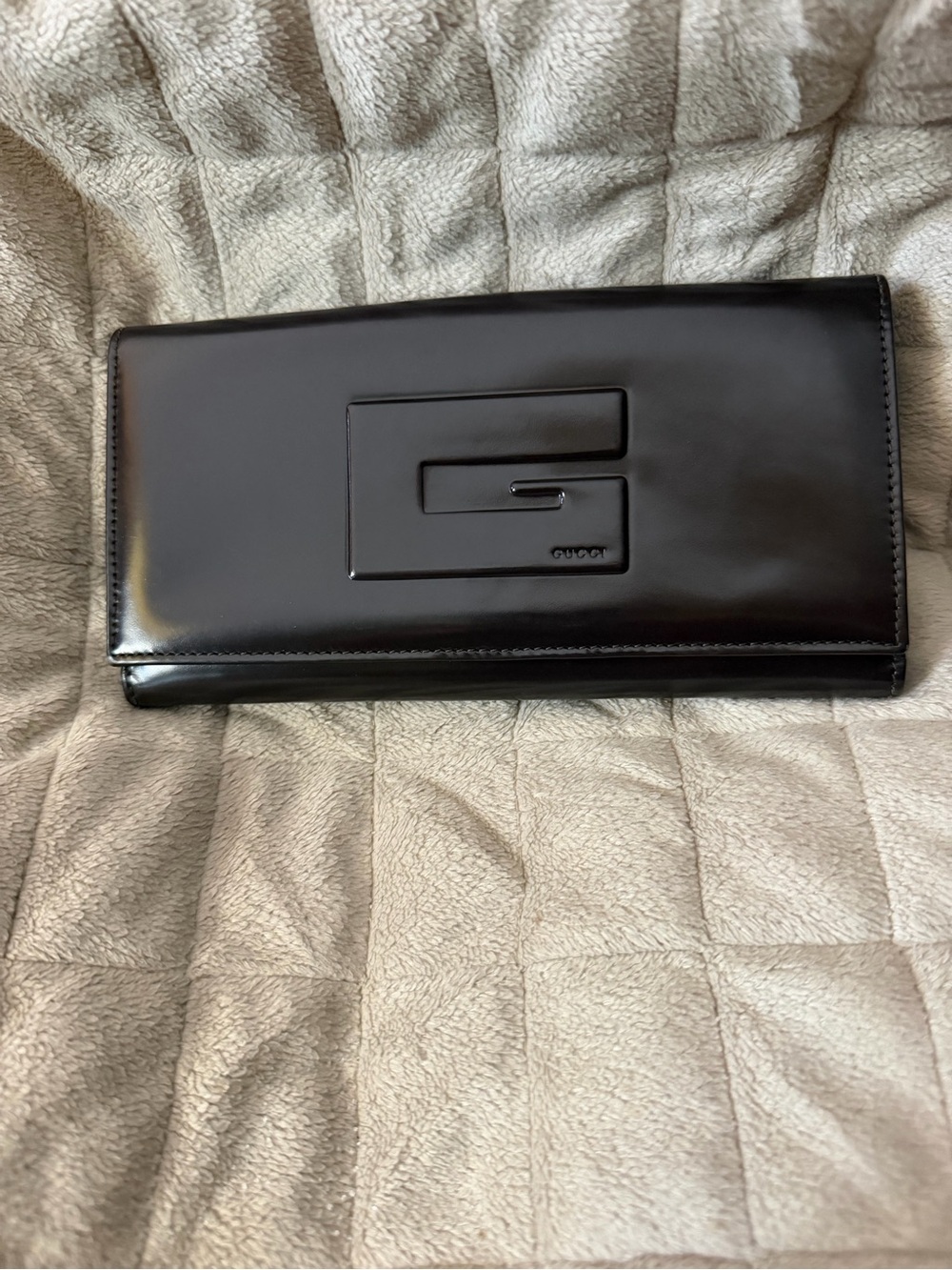 GUCCI Dark Brown Patent Leather Clutch Wallet with G Emblem on Front.